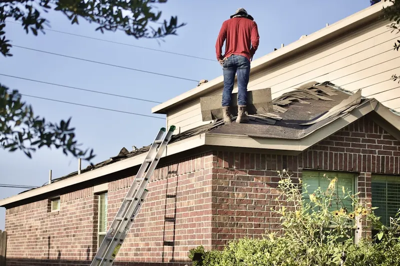 Professional roofer working on a residential roof in Addick Estates